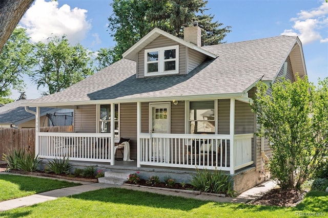 3976 S Washington St, Englewood, CO 80113 - view of front of house with a porch, roof with shingles, and a chimney