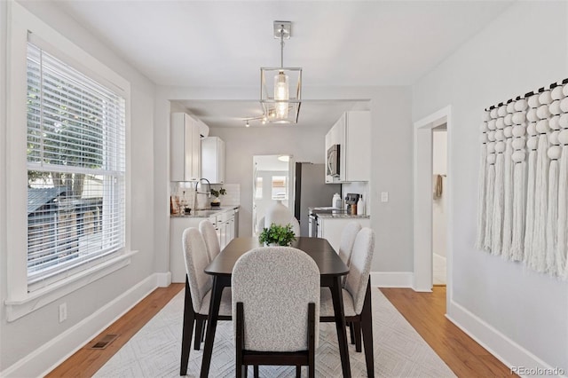 3976 S Washington St, Englewood, CO 80113 - dining room with light wood-style flooring and plenty of natural light