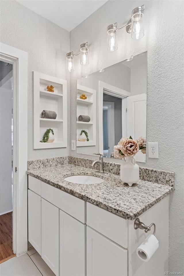 3976 S Washington St, Englewood, CO 80113 - bathroom featuring vanity and a textured wall