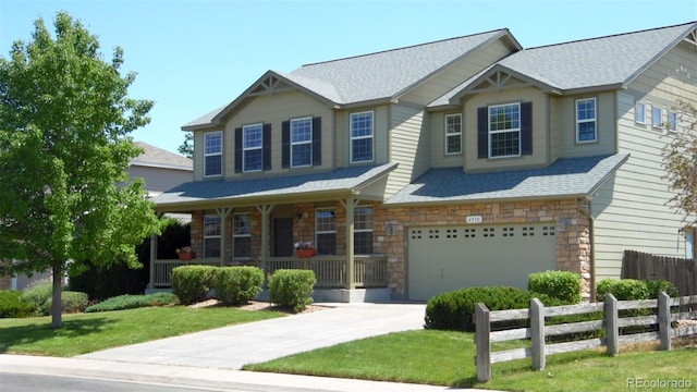 6910 E 131st Dr, Thornton, CO 80602 - craftsman-style house featuring covered porch, a garage, driveway, and stone siding
