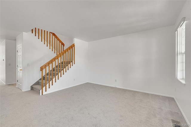 6910 E 131st Dr, Thornton, CO 80602 - unfurnished living room with stairway and carpet flooring