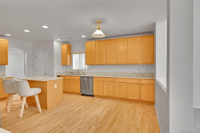 6910 E 131st Dr, Thornton, CO 80602 - kitchen featuring dishwasher, light wood-style flooring, light countertops, arched walkways, and recessed lighting