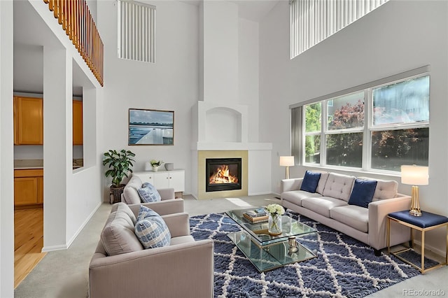 6910 E 131st Dr, Thornton, CO 80602 - living area with carpet, a high ceiling, and a fireplace