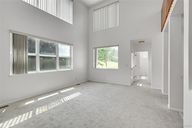 6910 E 131st Dr, Thornton, CO 80602 - unfurnished living room with carpet flooring and a towering ceiling