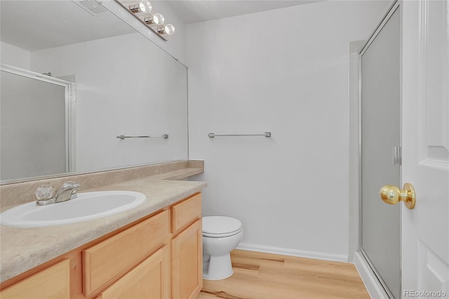 6910 E 131st Dr, Thornton, CO 80602 - bathroom with a stall shower, vanity, and wood finished floors