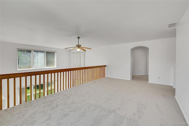 6910 E 131st Dr, Thornton, CO 80602 - unfurnished room featuring ceiling fan, arched walkways, and carpet floors