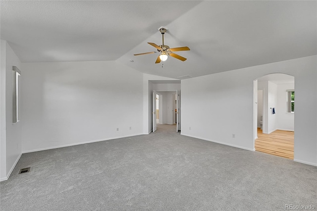 6910 E 131st Dr, Thornton, CO 80602 - carpeted spare room with arched walkways, lofted ceiling, and a ceiling fan