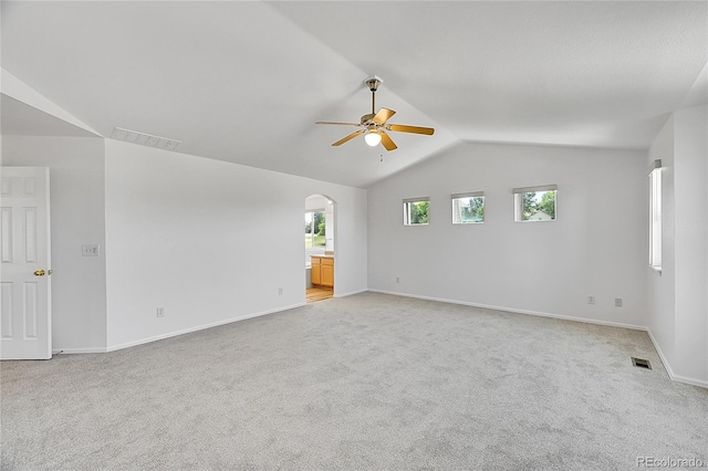 6910 E 131st Dr, Thornton, CO 80602 - empty room featuring ceiling fan, lofted ceiling, light colored carpet, and arched walkways