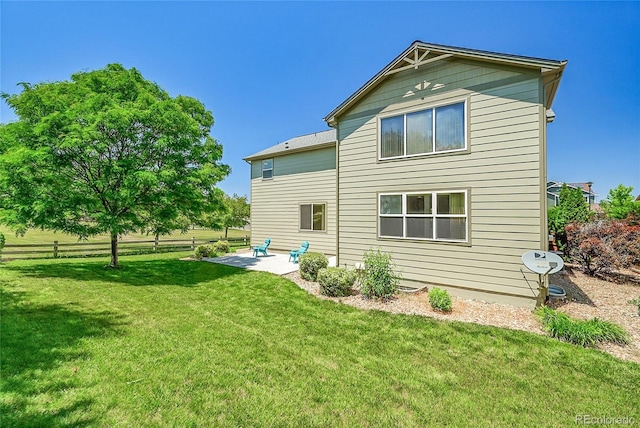 6910 E 131st Dr, Thornton, CO 80602 - back of house featuring a patio and a yard