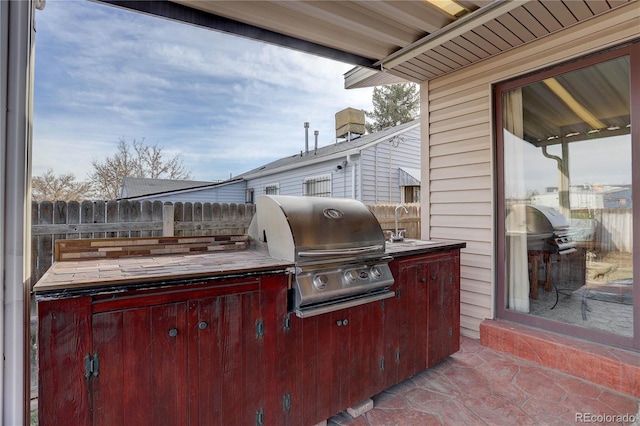 view of patio with sink, grilling area, and exterior kitchen