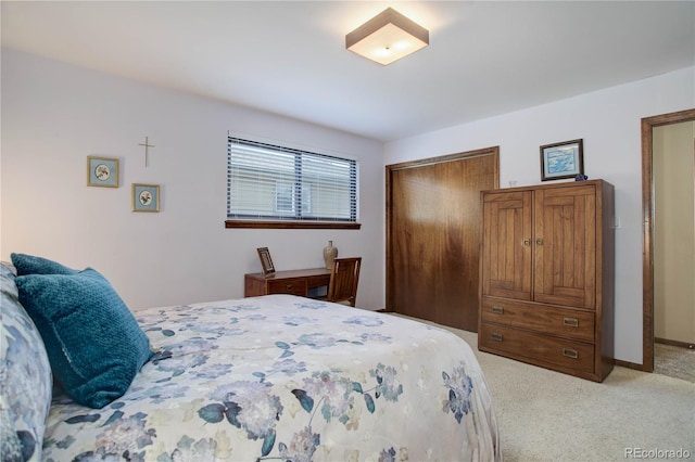 bedroom with light colored carpet and a closet