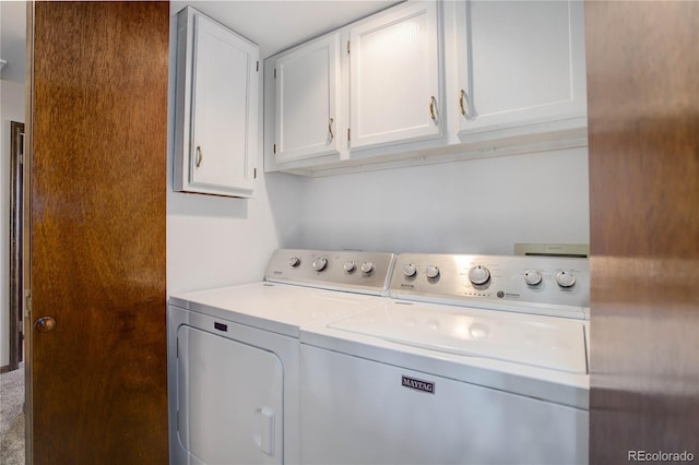 washroom with cabinets and washing machine and clothes dryer