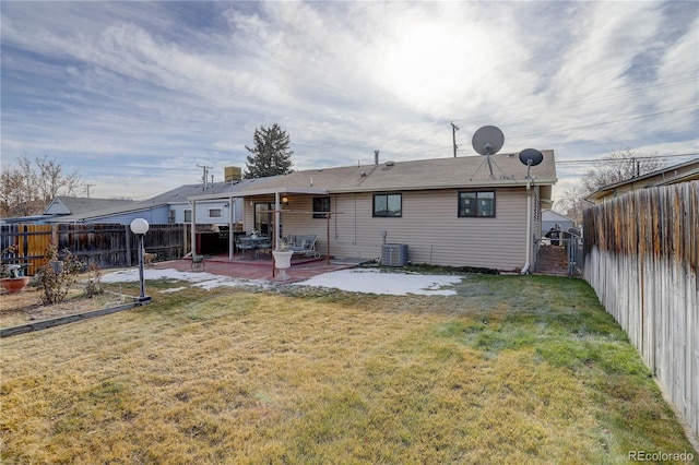 rear view of house with a yard, a patio, and central AC