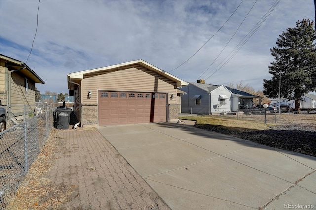 view of front of property featuring an outdoor structure and a garage