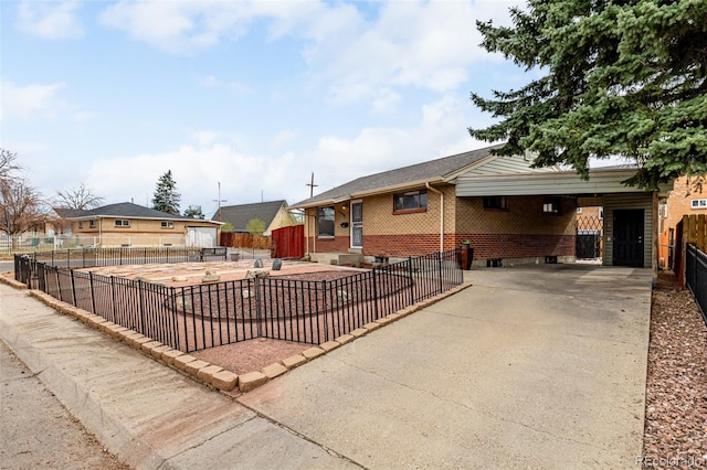 ranch-style house featuring brick siding, fence, and driveway