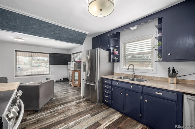 kitchen featuring open shelves, blue cabinetry, and a sink