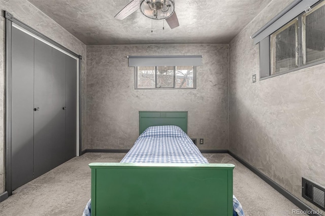 bedroom featuring ceiling fan, baseboards, visible vents, and carpet