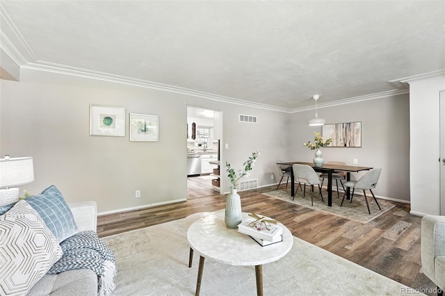 470 S Queen St, Lakewood, CO 80226 - living area featuring wood finished floors and ornamental molding