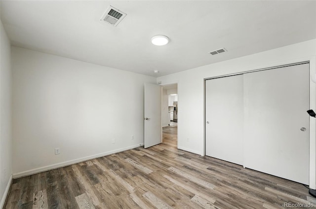 470 S Queen St, Lakewood, CO 80226 - unfurnished bedroom featuring light wood-style flooring and a closet