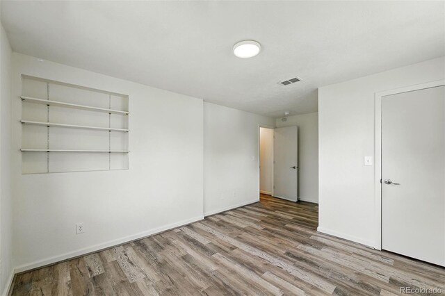 470 S Queen St, Lakewood, CO 80226 - unfurnished bedroom featuring wood finished floors and baseboards