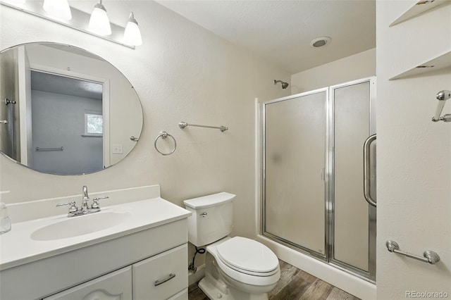470 S Queen St, Lakewood, CO 80226 - bathroom featuring wood finished floors, a shower stall, and vanity