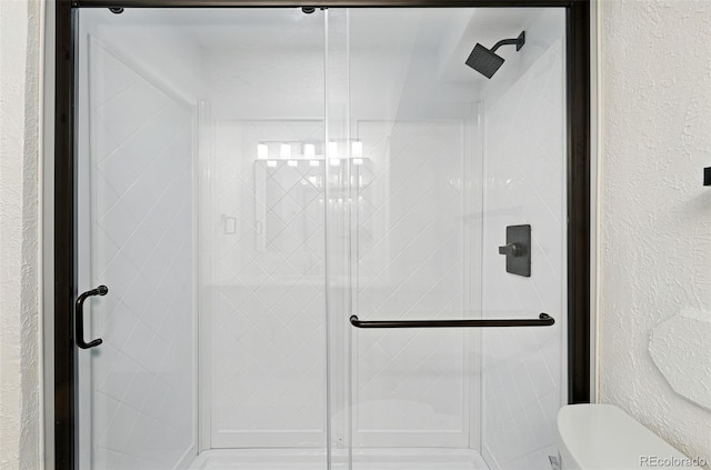 470 S Queen St, Lakewood, CO 80226 - bathroom with a shower stall and a textured wall