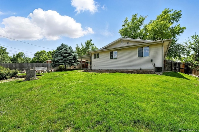 470 S Queen St, Lakewood, CO 80226 - rear view of house featuring a fenced backyard and crawl space