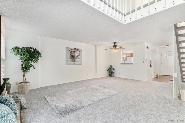 480 W Rockrimmon Blvd Unit D, Colorado Springs, CO 80919 - unfurnished living room featuring carpet floors, a ceiling fan, a textured ceiling, plenty of natural light, and baseboards