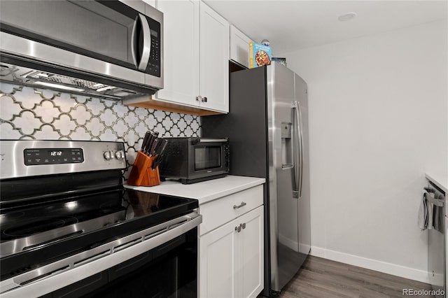 1160 S Monaco Pkwy Unit 6, Denver, CO 80224 - kitchen with stainless steel appliances, backsplash, white cabinetry, wood finished floors, and light countertops