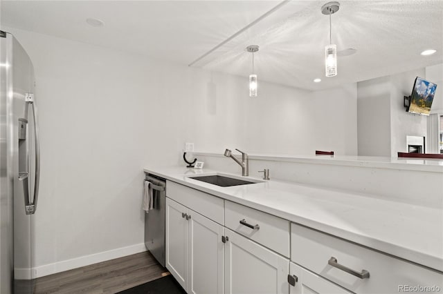 1160 S Monaco Pkwy Unit 6, Denver, CO 80224 - kitchen featuring stainless steel appliances, dark wood-style flooring, white cabinetry, light countertops, and recessed lighting