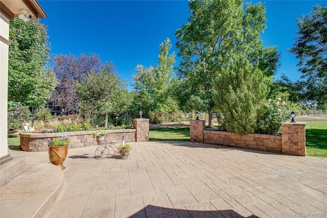 view of patio featuring fence