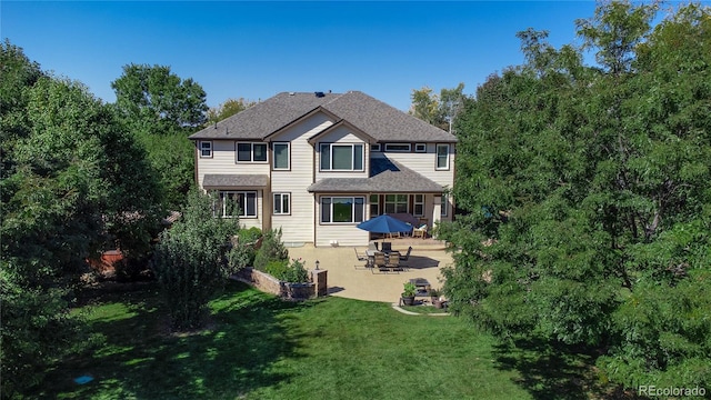 back of property featuring a yard and a patio area