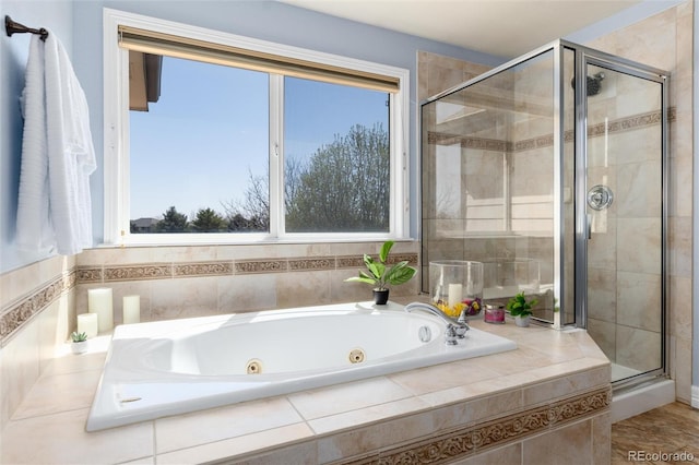full bathroom featuring a shower stall and a tub with jets