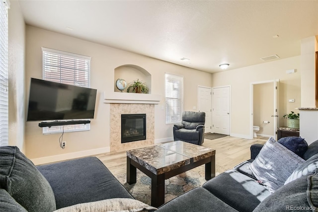 living room featuring light hardwood / wood-style floors and a fireplace