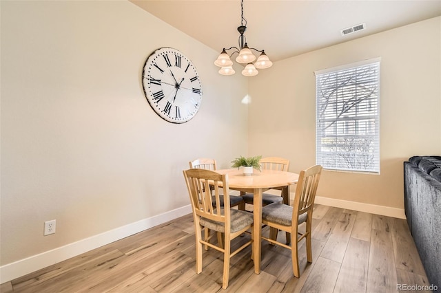 dining room featuring a chandelier and light hardwood / wood-style floors