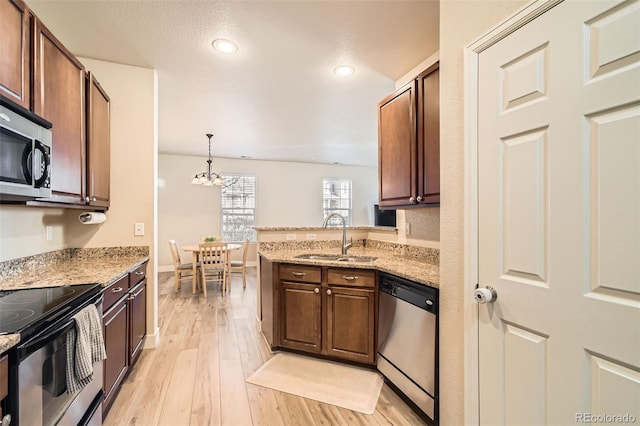 kitchen featuring pendant lighting, an inviting chandelier, sink, light hardwood / wood-style floors, and stainless steel appliances