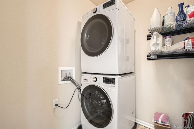 laundry room featuring stacked washer / drying machine