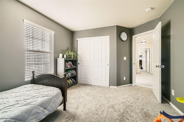 bedroom with carpet flooring and a closet