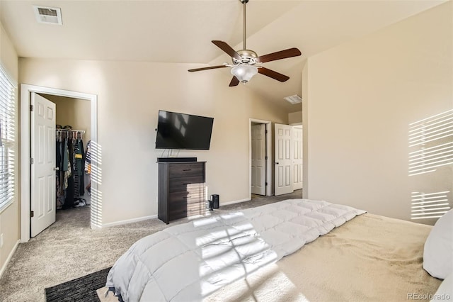 carpeted bedroom with vaulted ceiling, a closet, a spacious closet, and ceiling fan