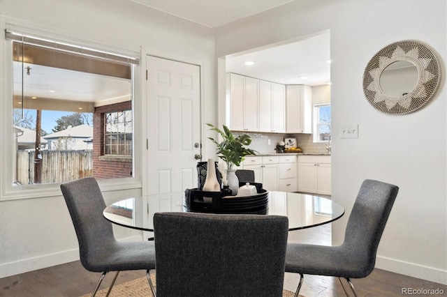 dining area featuring plenty of natural light, baseboards, and wood finished floors