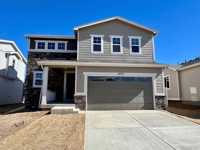 view of front facade featuring a garage, stone siding, and concrete driveway