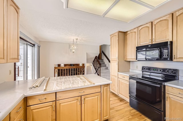 kitchen featuring light wood-style flooring, black appliances, and light brown cabinetry