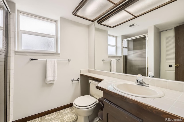 full bath featuring a stall shower, baseboards, toilet, visible vents, and vanity