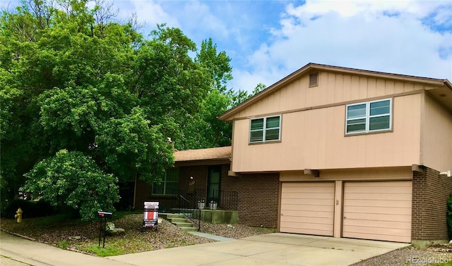 6411 W 82nd Dr, Arvada, CO 80003 - split level home with brick siding, concrete driveway, and a garage