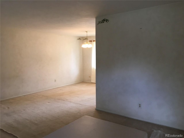6411 W 82nd Dr, Arvada, CO 80003 - spare room featuring a chandelier, carpet floors, and baseboards