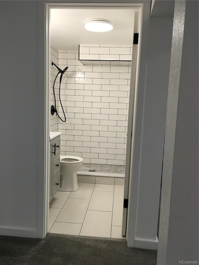 6411 W 82nd Dr, Arvada, CO 80003 - bathroom featuring a shower stall, toilet, vanity, and tile patterned flooring