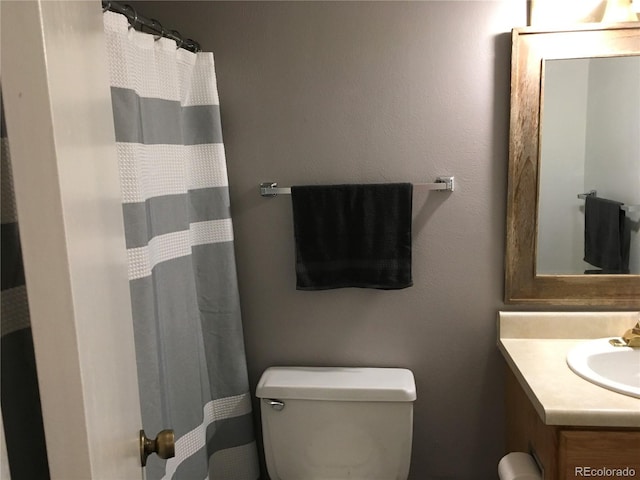 6411 W 82nd Dr, Arvada, CO 80003 - bathroom with toilet, vanity, and a shower with shower curtain