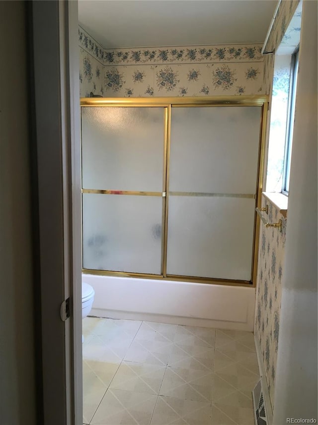 6411 W 82nd Dr, Arvada, CO 80003 - bathroom featuring toilet, enclosed tub / shower combo, and wallpapered walls