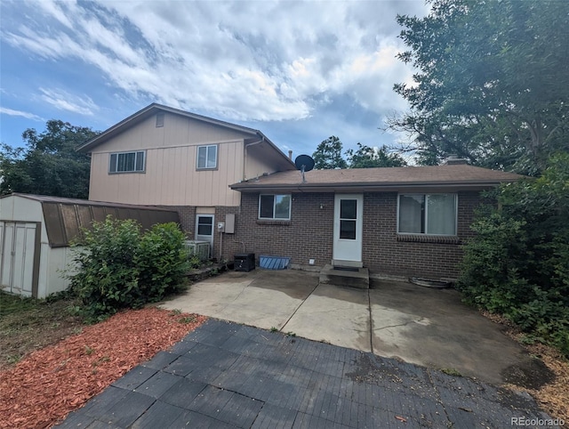 6411 W 82nd Dr, Arvada, CO 80003 - rear view of house with brick siding, a patio, and entry steps