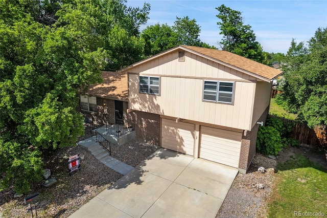 6411 W 82nd Dr, Arvada, CO 80003 - view of front of home with brick siding, concrete driveway, a garage, and roof with shingles